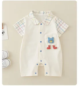 Detail of baby cotton romper featuring a cute bear pocket and checkered collar design