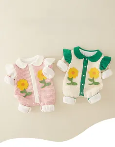 Detail of waffle fabric baby romper with sunflower patches and ruffled sleeves