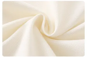 Close-up of white breathable pique cotton fabric for baby short sleeve romper