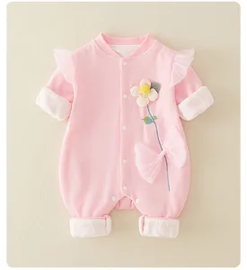 Detailed pink baby floral romper featuring lace ruffles and a large decorative bow