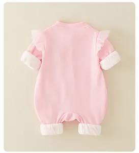 Detail of pink long-sleeve baby romper with mesh ruffles and waffle knit texture