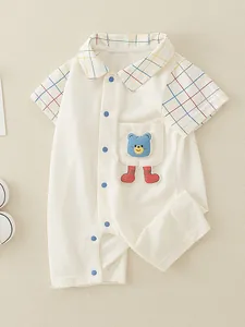 Short sleeve cotton baby romper in cream with rainbow plaid trim and bear applique