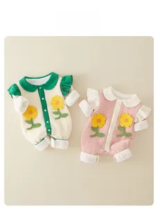 Close-up of baby waffle rompers with sunflower embroidery and ruffle sleeve detail