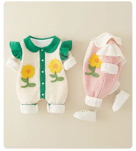 Detail view of waffle knit baby jumpsuits with sunflower embroidery and Peter Pan collars