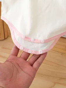 Cute cherry print baby girl romper with pink trim and snap button closure details