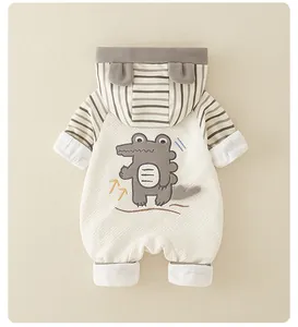 Detail of baby hooded romper with quilted fabric and cartoon crocodile on the back