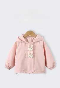 Detailed view of pink windproof jacket for girls featuring 3D cute white rabbit patches