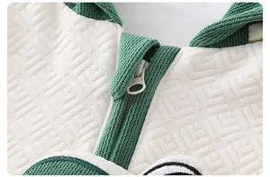 Macro detail of high-quality zipper and embossed geometric texture on newborn romper