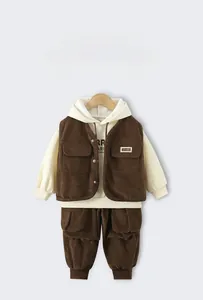 Close-up of boys corduroy vest and hoodie set with soft textured fabric details