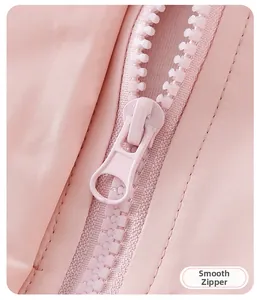 Detail shot of a smooth pink resin zipper on a girl's windbreaker jacket