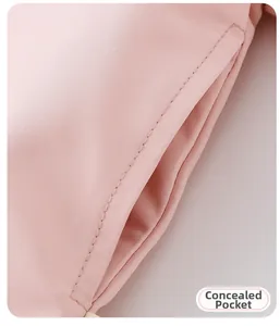 Detailed close-up of a hidden pocket on a light pink cartoon rabbit windbreaker jacket
