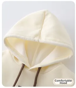 Detail of soft cream hoodie neckline with adjustable dark brown braided drawstrings
