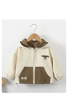 Detail of cartoon dog embroidery and color-block design on the hooded kids jacket