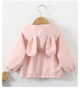 Close-up of pink hooded jacket featuring 3D bunny ears on hood and adjustable drawstrings