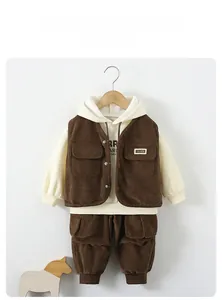 Detail of kids 3-piece set with brown corduroy vest and cargo pants on wooden hanger