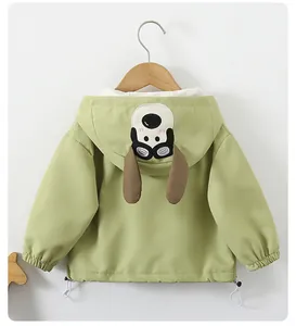 Detail of sage green hooded jacket featuring cartoon dog embroidery and adjustable drawstring