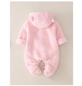 Close-up of pink winter baby romper featuring plush fleece fabric and hooded ears detail