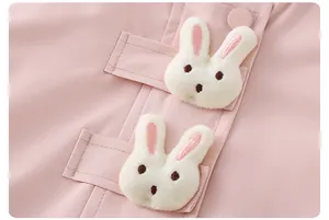 Close-up of pink toddler jacket featuring 3D plush bunny ears and matching buttons