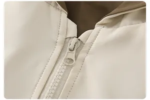 Detailed close-up of zipper and collar on an off-white windbreaker with brown lining