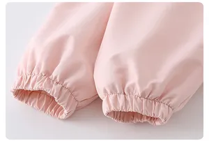 Detail of elastic cuffs on a light pink girls' jacket with neat stitching and smooth fabric