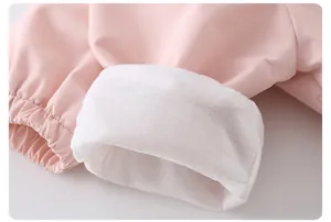 Detail of soft pink elastic cuffs and premium white lining on kids' rabbit windbreaker