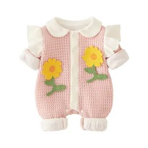Pink waffle knit baby romper with sunflower patches and white ruffle sleeve details