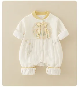 Detail of baby romper featuring traditional Chinese knots and floral embroidery texture