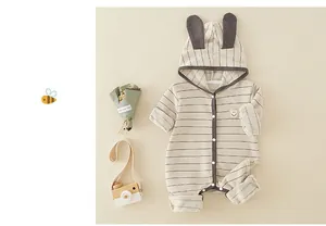 Detail of baby striped cotton romper with bunny ears hood and snap button closure