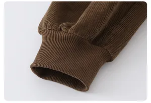 Detail of dark brown corduroy sleeve showing tight elastic ribbed cuff texture