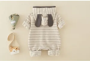 Detail of baby striped cotton bodysuit with cute rabbit ears and long sleeves