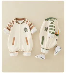 Detail of baby cotton dinosaur rompers with striped patterns and cute embroidery