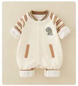 Detail of waffle knit fabric and cute dinosaur embroidery on baby cotton romper