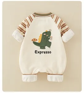 Detail of baby cotton romper with cartoon dinosaur print and striped raglan sleeves