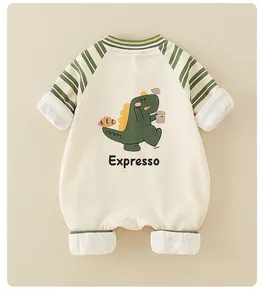 Close-up of baby waffle cotton bodysuit with green striped sleeves and dinosaur print