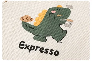 Close-up of cute cartoon dinosaur with coffee embroidery on white waffle cotton fabric