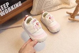 Detail of pink toddler sneakers with velcro strap and cute 3D horse decoration