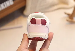 Close-up of children's sports shoe showing breathable mesh and non-slip rubber outsole