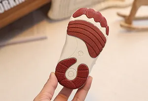 Detail of baby shoe sole with multi-textured anti-slip pads and size 17 marking