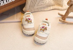 Close-up of baby sneakers with soft non-slip soles and a cute rocking horse icon