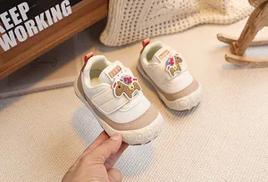 Detail of baby walking sneaker featuring breathable mesh and cute cartoon horse patch