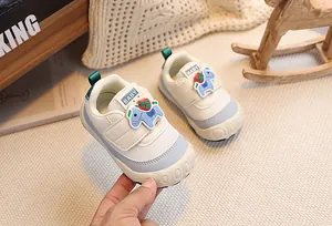 Detailed macro view of baby sneaker mesh upper with blue pony strap and strawberry print