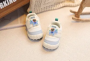 Close-up of cream baby walking shoes with cute cartoon pony and velcro strap detail
