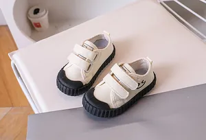 Detail of kids canvas shoes featuring secure velcro straps and a durable rubber toe cap