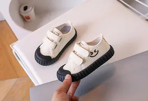 Close-up of children canvas shoes featuring double velcro straps and non-slip rubber soles