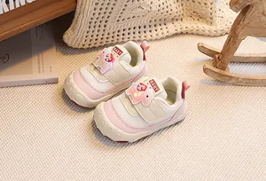 Detail view of pink baby walking shoes with velcro straps and a soft anti-slip sole