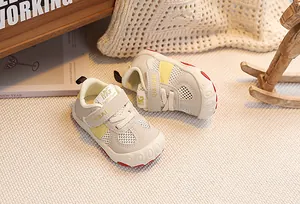 Close-up of toddler walking shoes with breathable mesh, velcro strap, and anti-collision toe