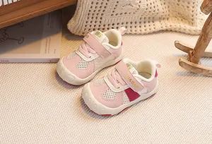 Detailed close-up of pink and beige breathable mesh baby sneakers with protective toe cap