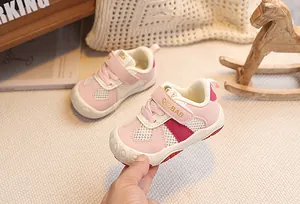 Detail of pink toddler shoes showing breathable mesh and protective toe cap for safety