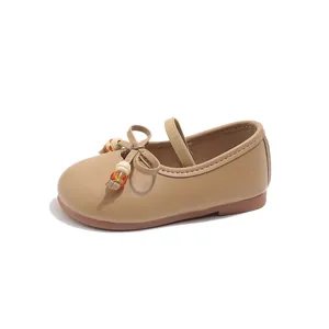 Kids khaki Mary Jane shoes with matte leather finish and decorative beaded bow detail