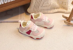 Close-up of pink and beige toddler sneakers with breathable mesh and Velcro strap